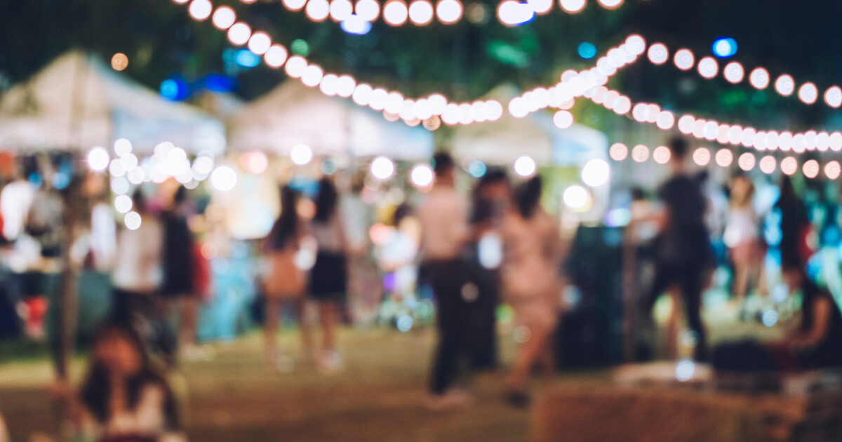 Outdoor event party with lighting and people blurred background